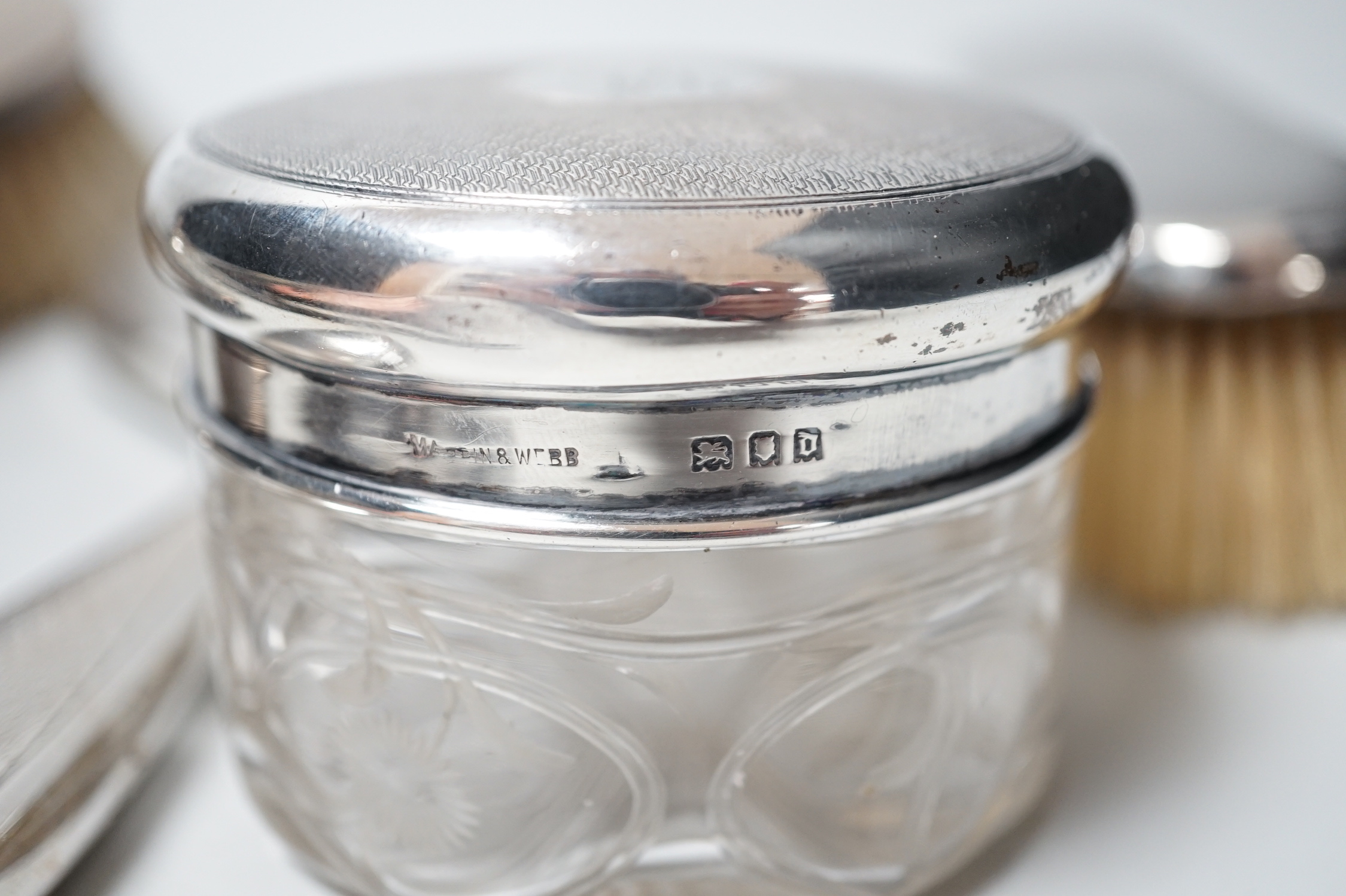 A George V silver mounted five piece dressing table set, two Georgian silver punch ladles and cased tea knives.